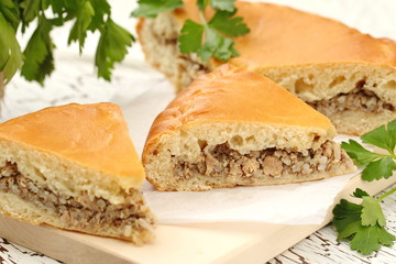 Traditional russian pie with meat and rice