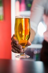 Bartender serving a glass of beer