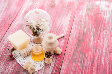 Obraz na płótnie Canvas spa treatment - star anise, honey, salt, arranged with soap bar, pebbles and towels on wood