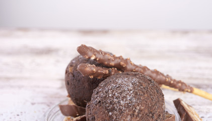 Cupcake with chocolate on wooden background