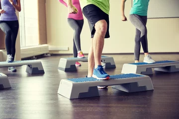  group of people flexing legs on step platforms © Syda Productions