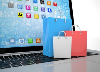 laptop and  shopping pags on white background