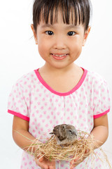 Asian Little Chinese Girl Holding Small Bird in hands