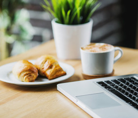 technology, business and modern living concept - open to close the laptop and coffee Cup on table in cafe