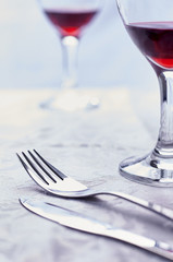 Glasses of wine with fork and knife