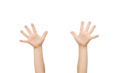 close up of little child hands raised upwards