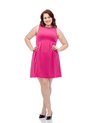 happy young plus size woman posing in pink dress