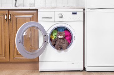 Teddy bear in a washing machine.