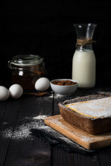 chocolate cheesecake with vanilla filling on a dark background