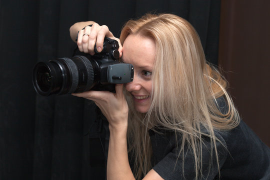 female photographer taking pictures indoors