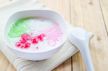 Tub Tim Krob ,Stuffed Water Chestnut in Syrup and Coconut Milk on wood table thailand dessert