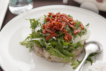 Tableware. Salad on white decorative plate