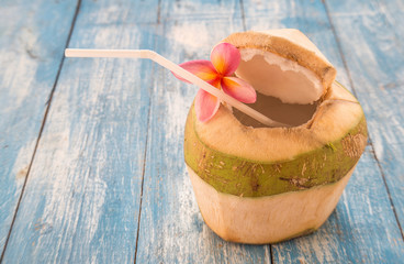 Young coconut,Plumeria on blue wooden floor.