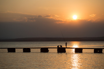 fisherman on sunset at sea