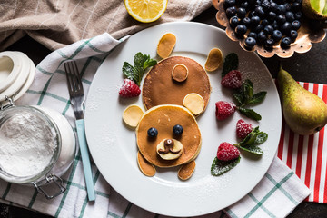 Top view on pancakes in the shape of a bear