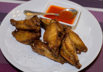 Chicken fried dish with chilli sauce.