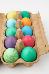 Naklejka na ściany i meble Colourful painted easter eggs in egg carton