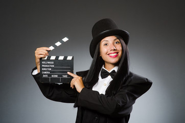 Woman with vintage hat and movie board