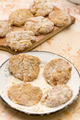Prepared meatballs for frying on the kitchen table