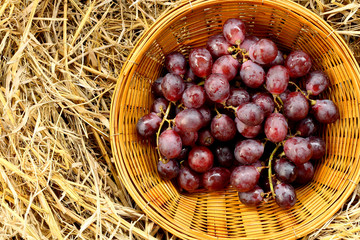 black organic grapes in a wicker basket