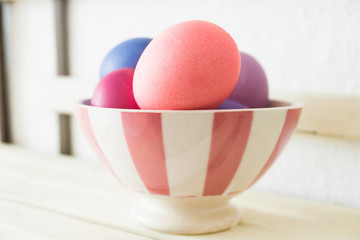 Easter eggs on a shelf in a bowl