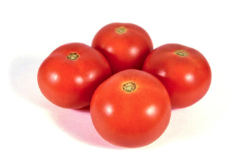 Four red tomatoes macro or close up isolated on white background