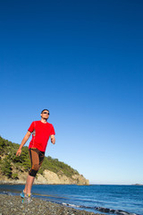 Man running on a rural road during sunset in the mountains