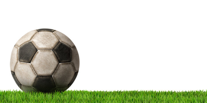 Football - Soccer Ball with Green Grass / Detail of an old black and white soccer ball (Football) isolated on white background with green grass