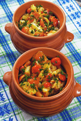 Fried potatoes with mushrooms and dill in a pots