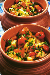 Fried potatoes with mushrooms and dill in a pots