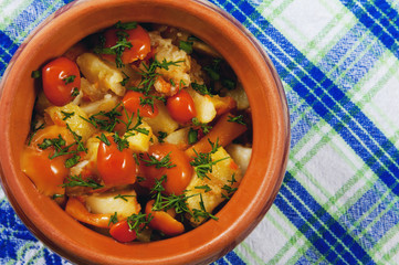 Fried potatoes with mushrooms and dill in a pots