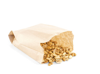 Processed peanuts in paper bag over white background with copy-space, shallow focus