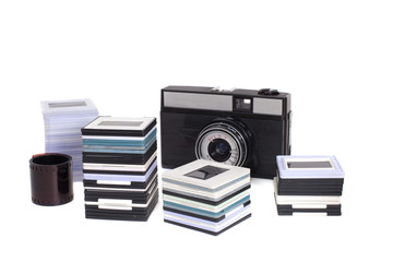 Old SLR camera and plastic frames with slides, isolated on white bacground