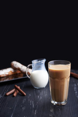 Caffe latte on dark background. Culinary coffee drinking.