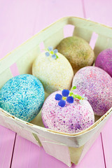 Sprinkled Easter eggs in a wooden basket