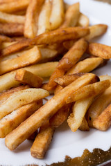 Fototapeta na wymiar Close macro view of french fries on the plate