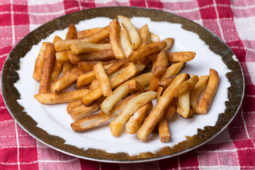Fresh fried french fries on the plate