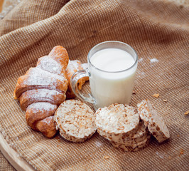 Beautiful breakfast. Milk, bread and croissant.