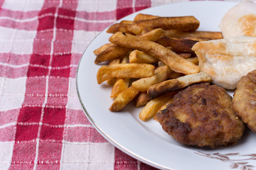Served chichen meat beef meatballs and french fries