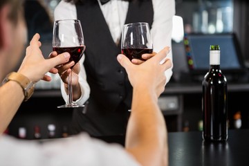 Bartender serving glasses of wine