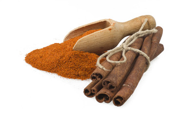 cinnamon sticks with powder on the white background