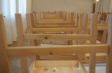 Fototapeta na wymiar Upside-down wooden chairs in the closed restaurant