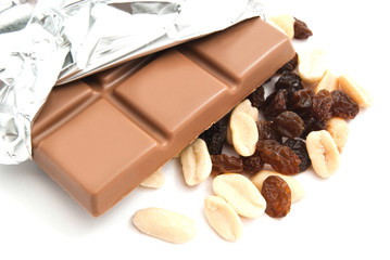 raisins, peanuts and chocolate bar on white