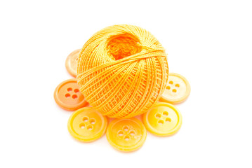 yellow buttons, and ball of thread on white