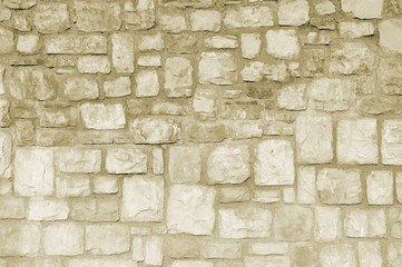 Stone wall closeup in sepia tones. For texture or background.