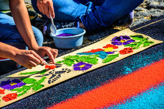 Locals make Lent carpet of dyed sawdust for procession in Antigua, Guatemala.
