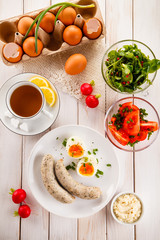 Easter breakfast - eggs, boiled white sausages and vegetables