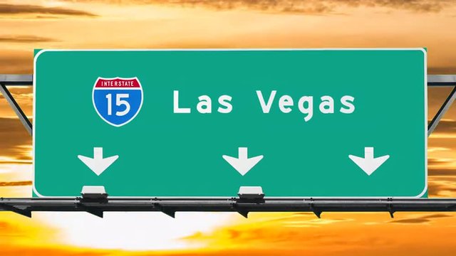 Las Vegas interstate 15 freeway sign with sunrise sky time lapse.