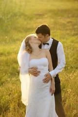 Bride and Groom Posing in the Field, filled with light