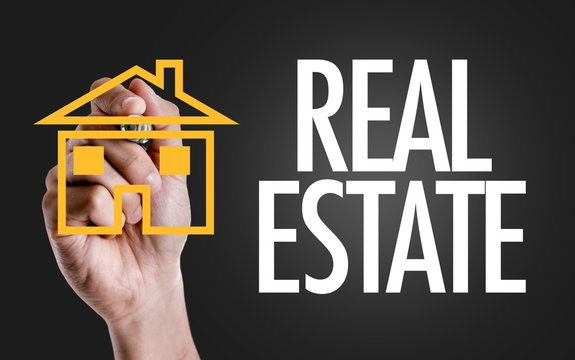 Hand writing the text: Real Estate